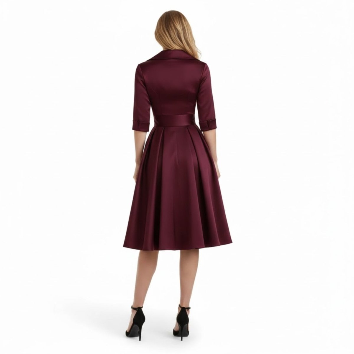 Model posing with hands on hips, showcasing the flattering silhouette of the black Seraphina dress.