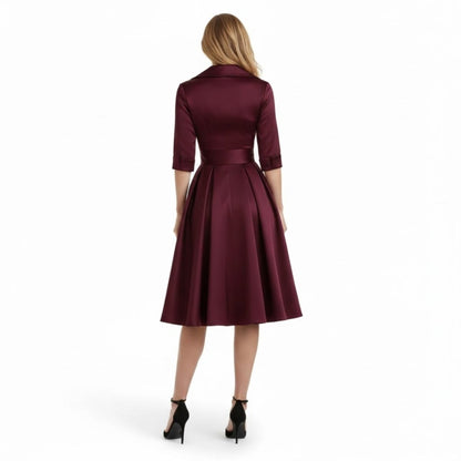 Model posing with hands on hips, showcasing the flattering silhouette of the black Seraphina dress.