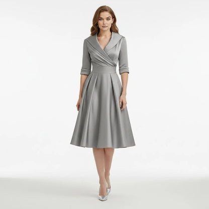 Detail of the V-neckline of the Seraphina wrap midi dress, highlighting its unique tailored character.