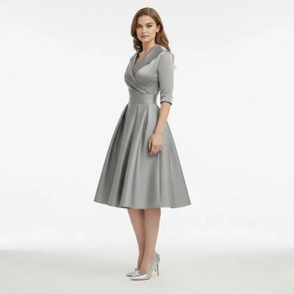 Full-length shot of the Seraphina dress in burgundy, paired with pointed court shoes for an occasion.