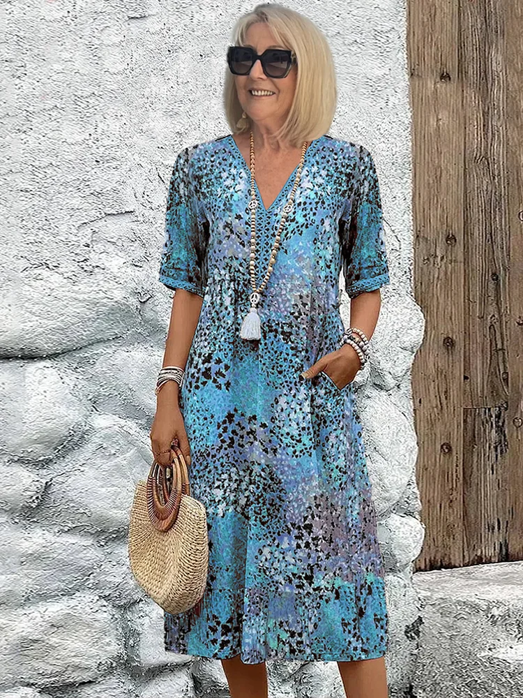 Side profile of a woman walking playfully, showcasing the flowing silhouette of the comfortable vibrant midi dress.