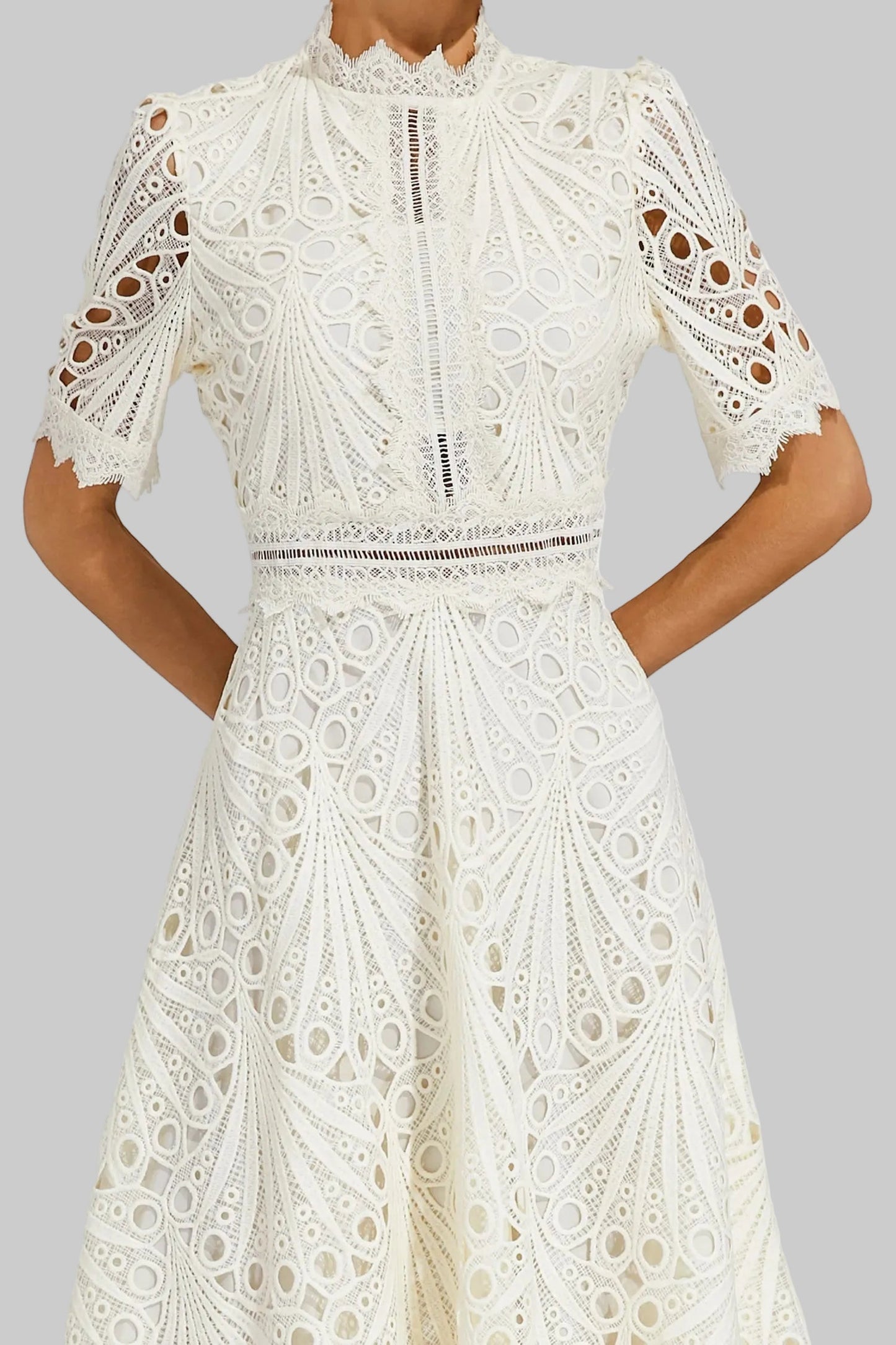 Side profile of a model wearing the pink Seraphina lace midi dress, highlighting the A-line skirt.
