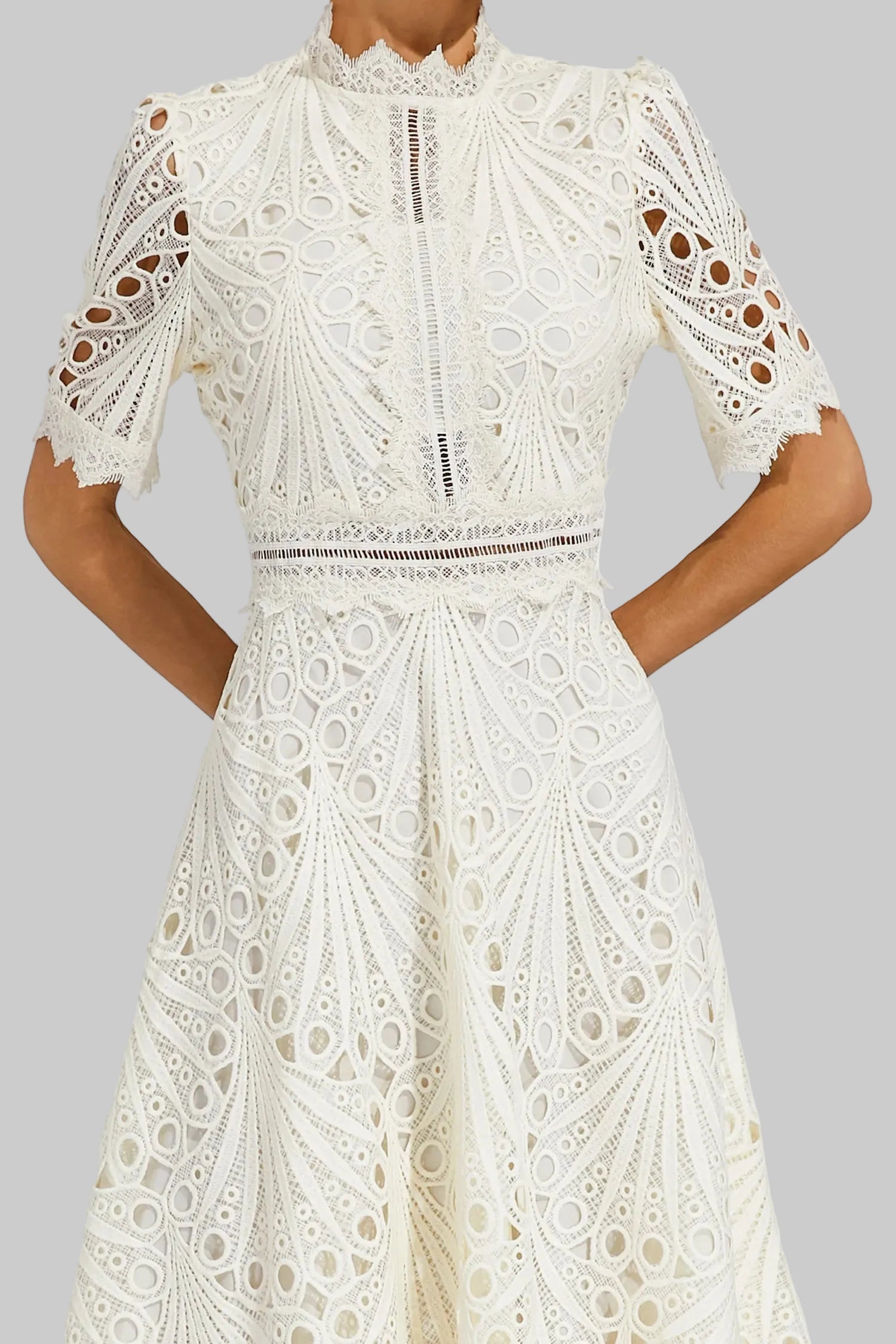 Side profile of a model wearing the pink Seraphina lace midi dress, highlighting the A-line skirt.