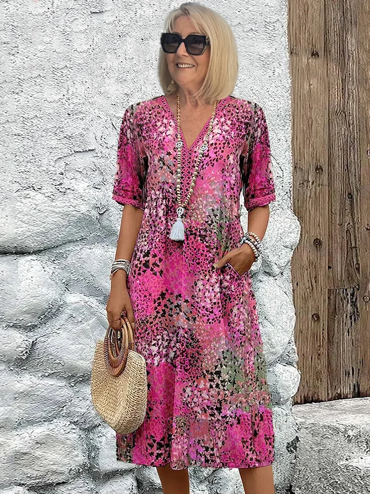 Close-up detail of the intricate, cheerful print on the fabric of the casual vibrant midi dress.