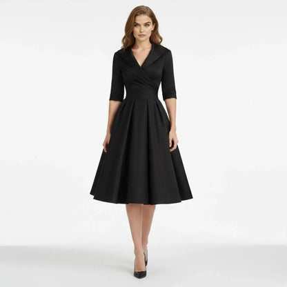 Back view of the Seraphina dress in a rich burgundy, showing the flowing A-line skirt in motion.
