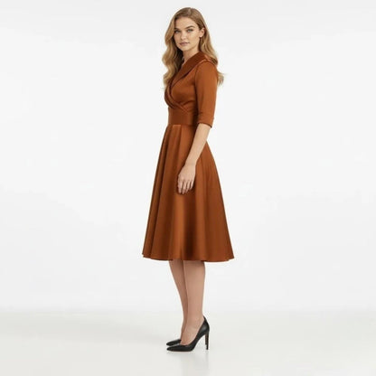 Overhead shot of the pleated detail on the A-line skirt of the timeless Seraphina wrap midi dress.