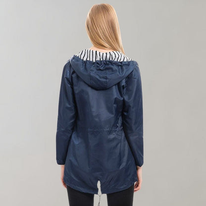 A vibrant yellow fashionable waterproof jacket laid flat, showcasing its smooth waterproof textile.