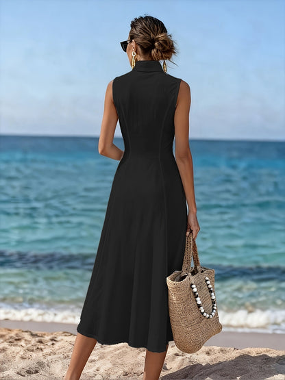 Side profile of the woman in the green flowy maxi dress, highlighting the relaxed fit and sleeveless design for summer.