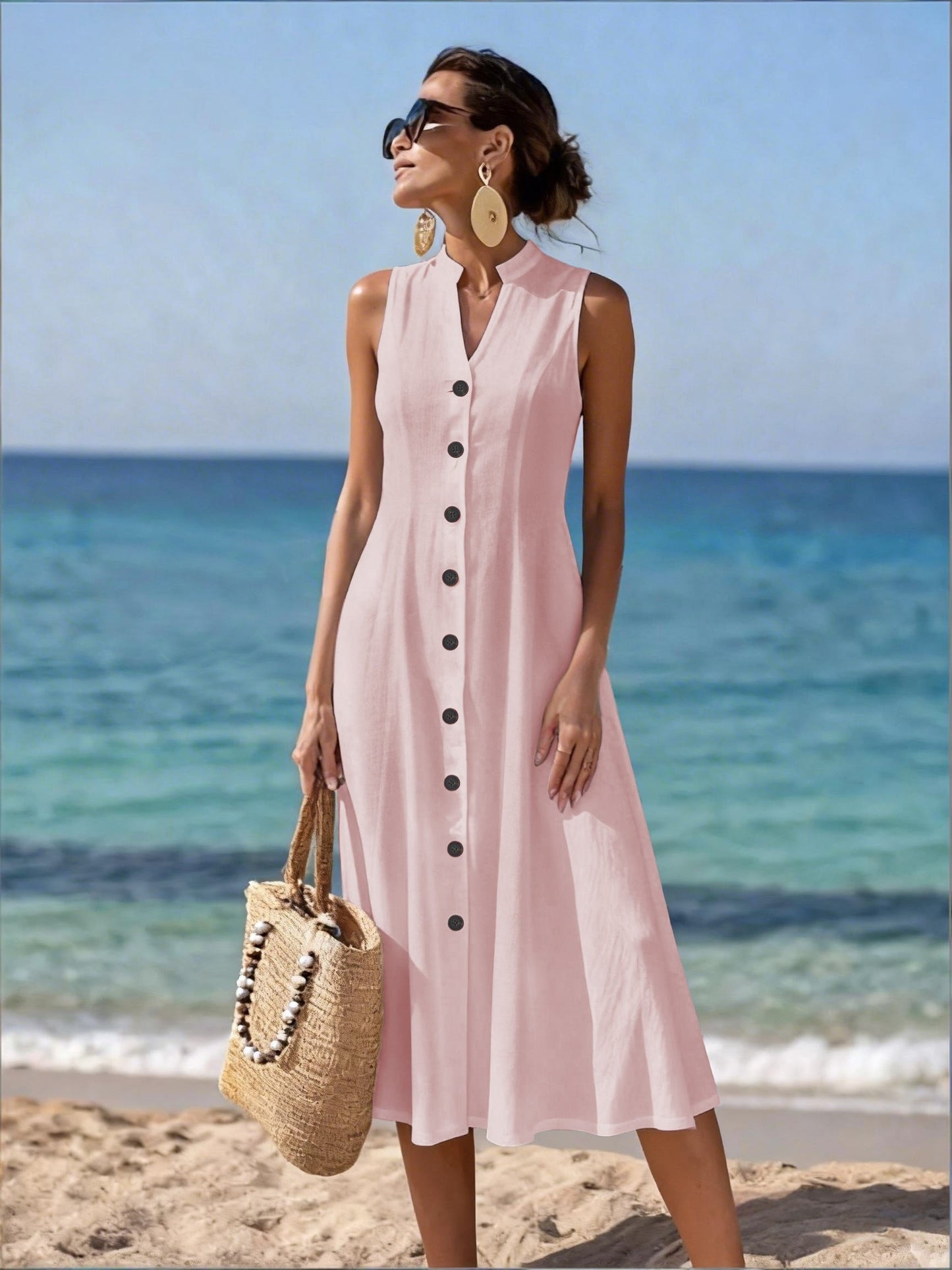Close-up of the delicate button accents on the bodice of the white flowy maxi dress, showing material detail.