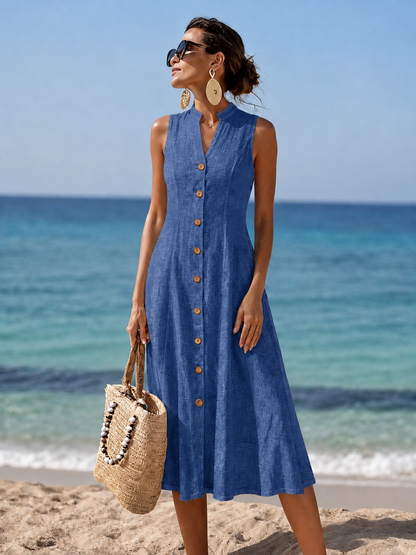 Woman happily twirling in the red flowy maxi dress on a sunny beach, emphasizing comfort and freedom of movement.