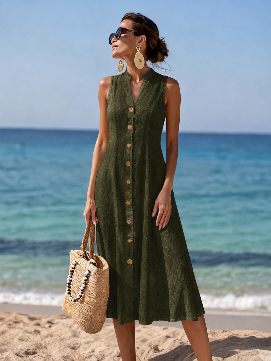 Detail shot of the V-neckline and shoulder strap of the black flowy maxi dress, showcasing fabric texture.