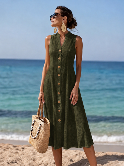 Detail shot of the V-neckline and shoulder strap of the black flowy maxi dress, showcasing fabric texture.