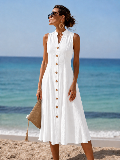 Woman relaxing on a patio in the stylish yellow flowy maxi dress, ideal for warm weather comfort.
