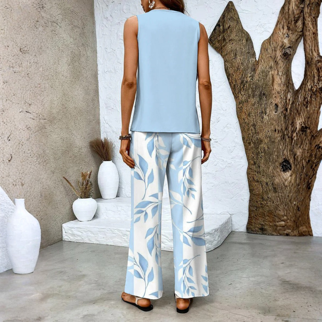 Close-up detail of the fabric and leaf pattern on the wide-leg pants of the elegant summer set.
