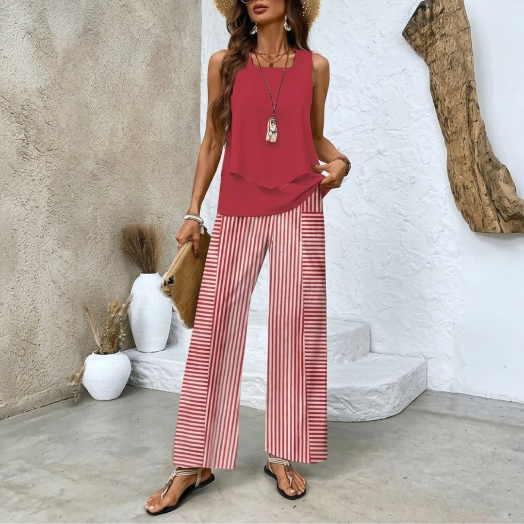 Rear view of the woman in the creme elegant summer set, showing the back of the top and pants.
