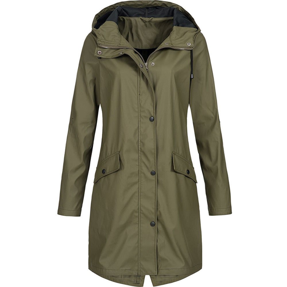 Front view of a vibrant dark green waterproof jacket on a model, showcasing its flattering fit and style.