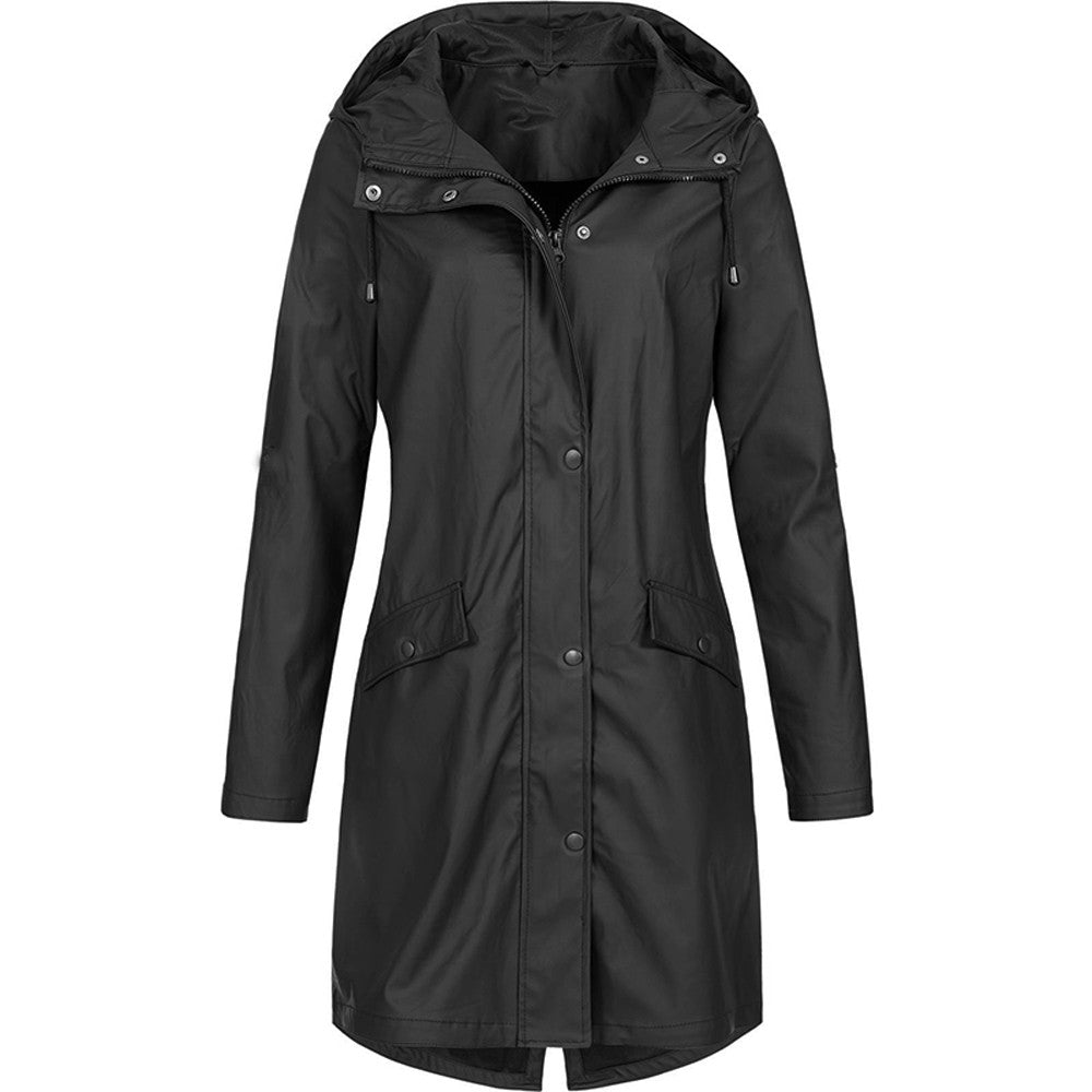 A woman walking in the rain with a green waterproof jacket, illustrating its practical use and protection.