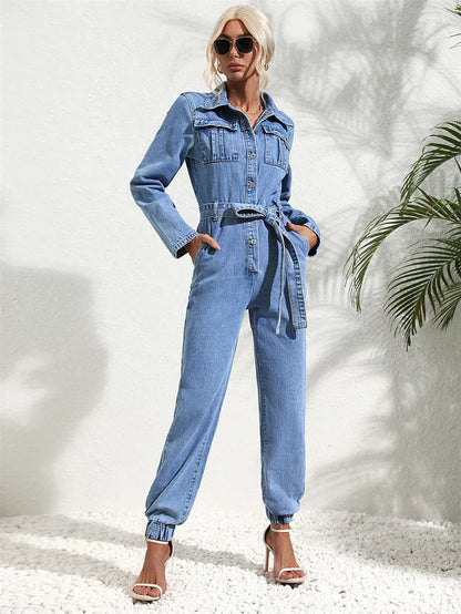 Close-up of the belted waist and button details on the front of the casual denim jumpsuit.
