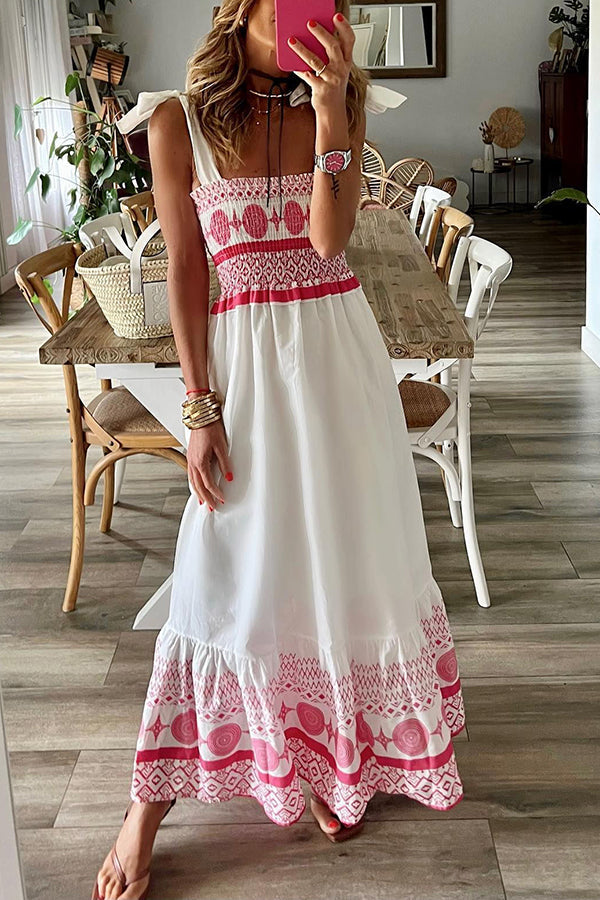 Front view of a model wearing the white Talia boho maxi dress, showcasing its smocked bodice and flowy skirt.