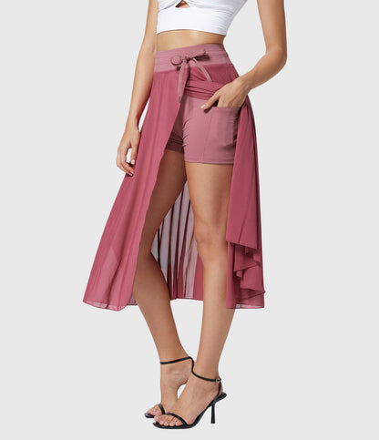 Model in a playful pose wearing the grey transformable fluid skirt, capturing the fun and energetic vibe.