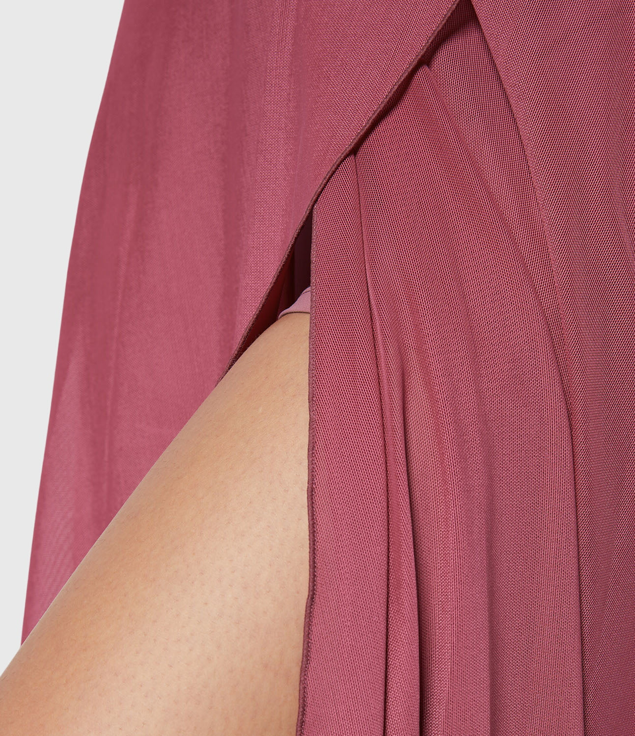 Frontal view of the turquoise transformable fluid skirt, with hands adjusting the waist tie for a personalized fit.