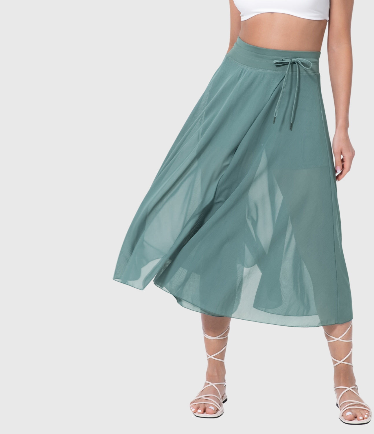 Model posing stylishly in a violet transformable fluid skirt, highlighting the elegant drape and integrated shorts detail.