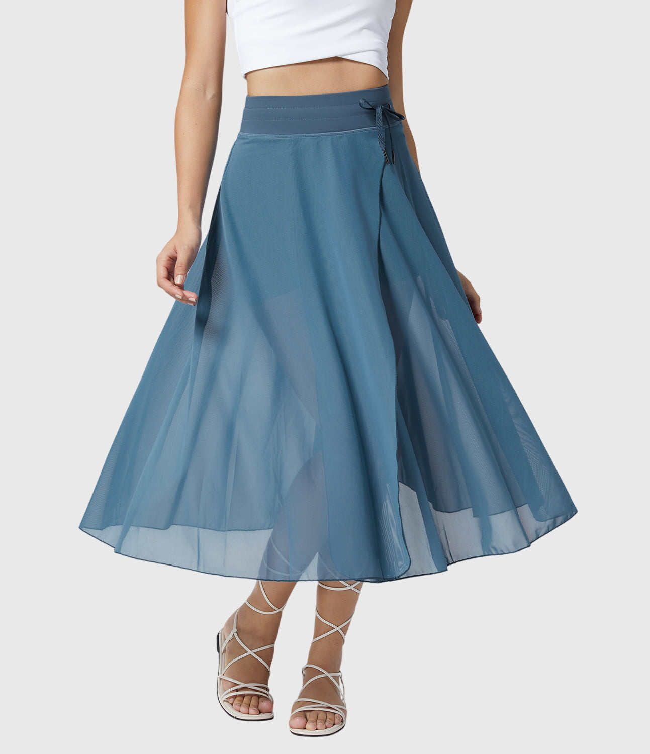 Outdoor shot of the grey transformable fluid skirt, blending seamlessly with a natural, casual setting.