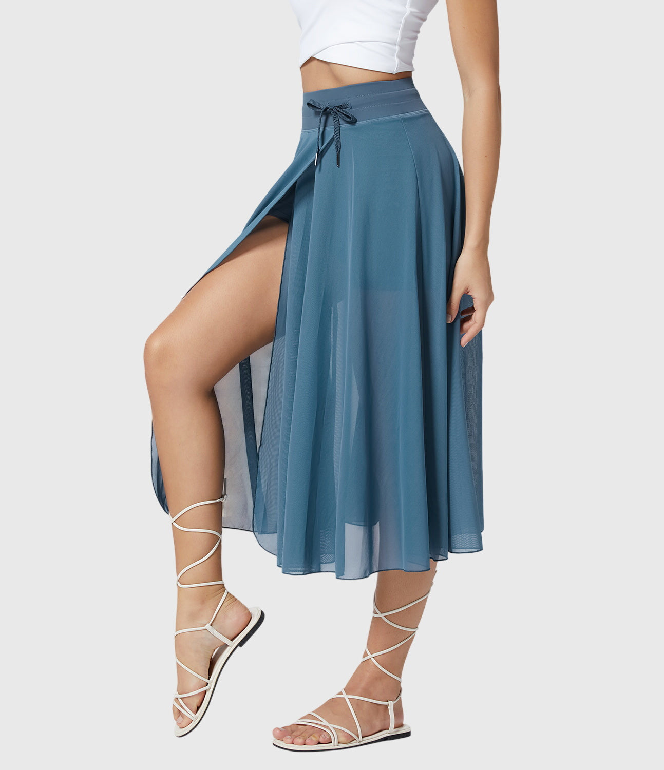 Three-quarter view of the turquoise transformable fluid skirt, emphasizing its flattering high-waisted design.