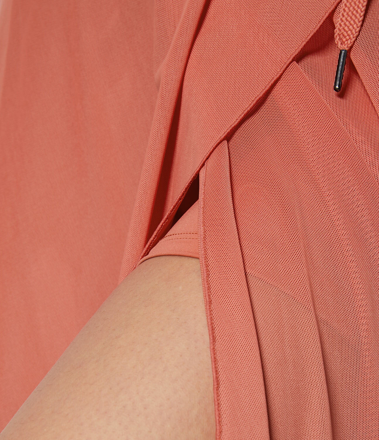 Detail of the orange transformable fluid skirt's stitching, showcasing the attention to quality and craftsmanship.