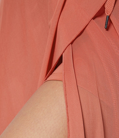 Detail of the orange transformable fluid skirt's stitching, showcasing the attention to quality and craftsmanship.