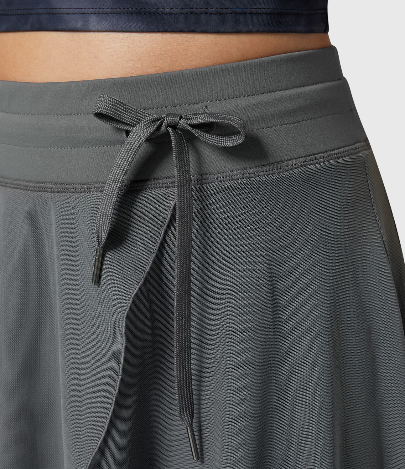 Model in a relaxed pose wearing the violet transformable fluid skirt, ideal for comfort and style on the go.