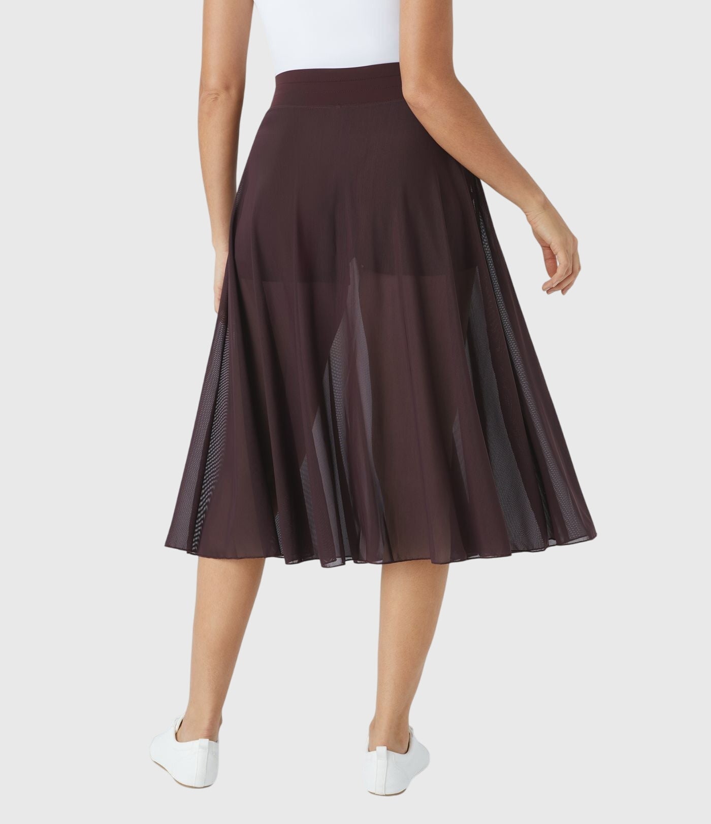 A close-up on the waistband of the black transformable fluid skirt, showing the secure and comfortable fit.