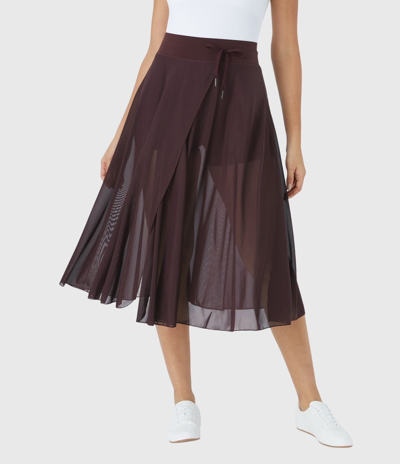Model twirling in the blue transformable fluid skirt, capturing the dynamic and playful essence of the garment.