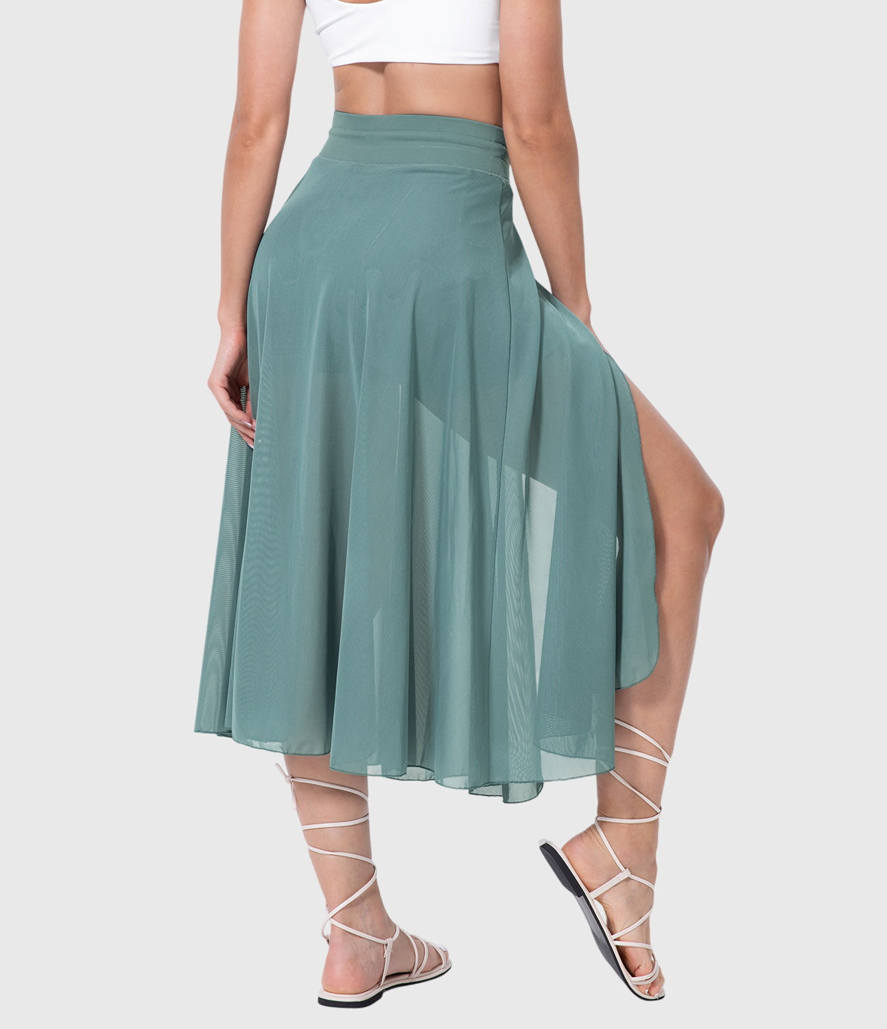 Back view of the black transformable fluid skirt, showing the graceful movement and comfortable high-waist fit.