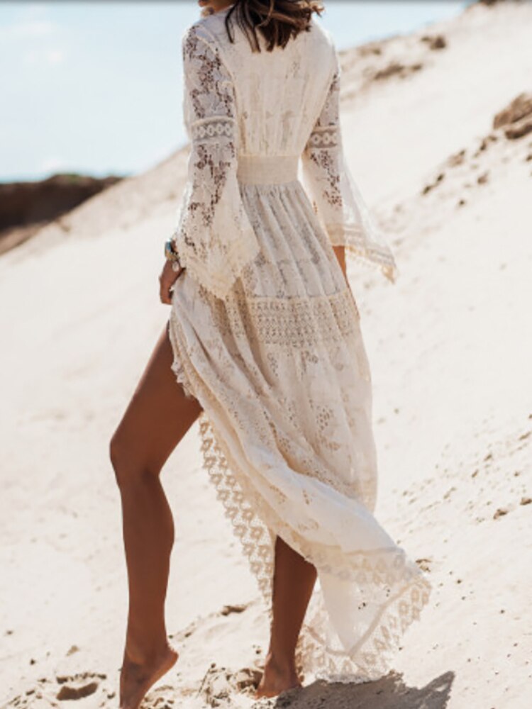 Lifestyle shot of a woman confidently posing in the sleeveless Seraphina elegant flowy dress at an outdoor event.