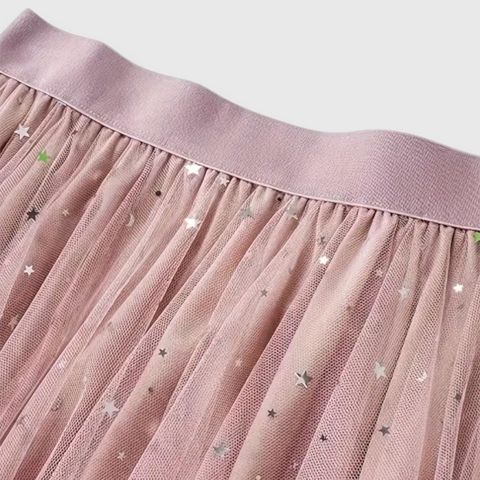 Close-up detail of the high-waisted band and the shimmering fabric of the whimsical tulle midi skirt.