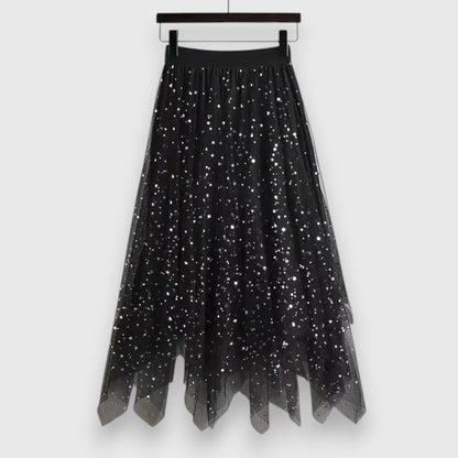 Side view of a woman gracefully walking in the black Valentina tulle midi skirt, highlighting its fluid movement and midi length.