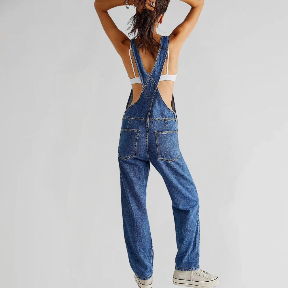 Back view of the light blue denim dungarees, highlighting the elegant cross-back strap design.