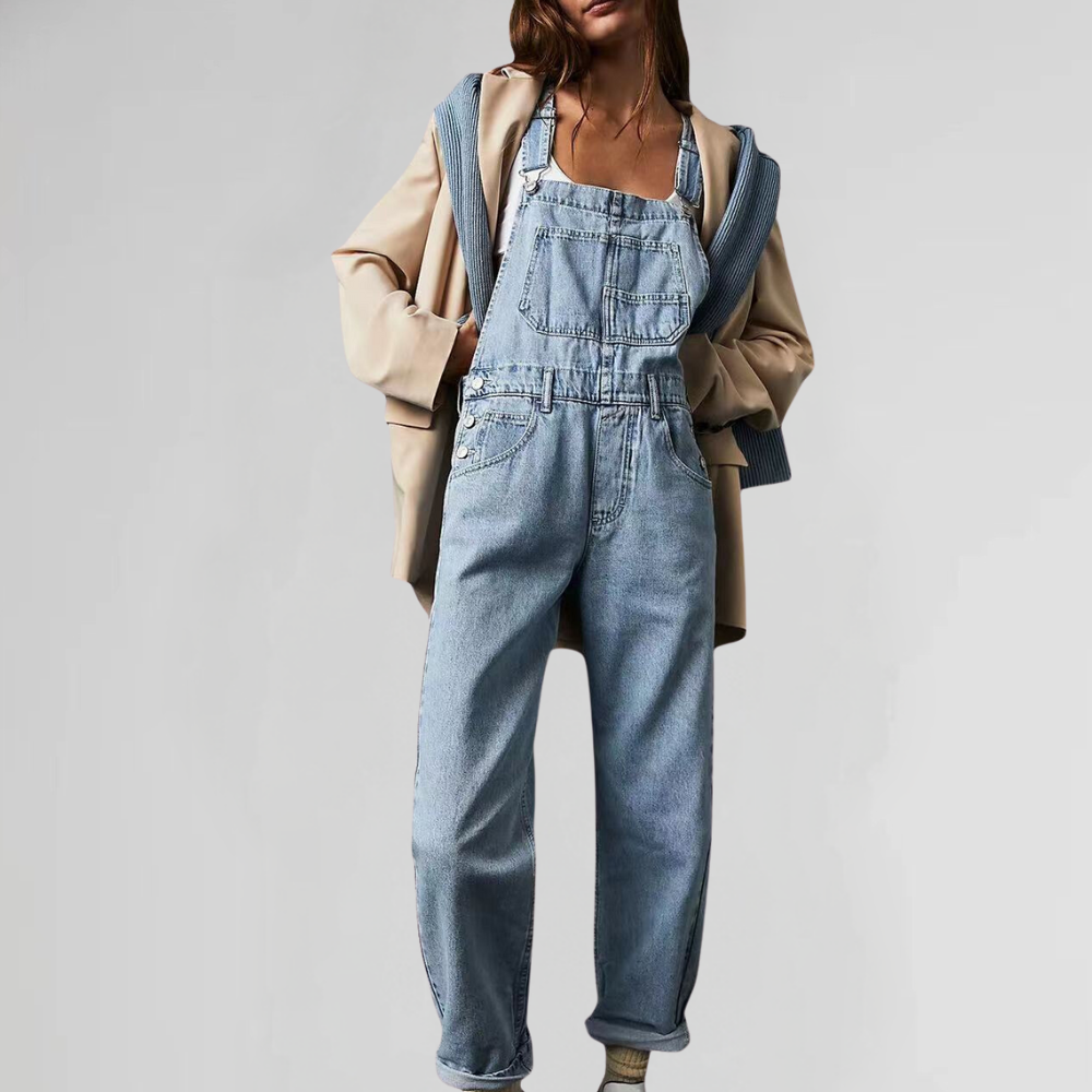 Detail shot of the functional front pockets on the light blue denim dungarees, perfect for essentials.