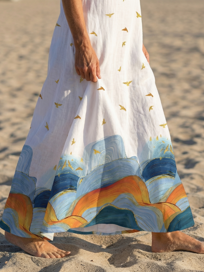 Side profile of the woman in the white Seraphina flowy maxi dress, highlighting the graceful drape and sleeveless style.