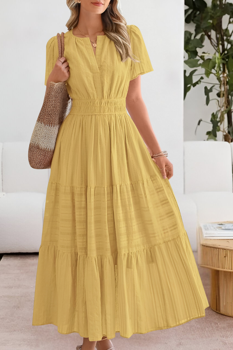 Yara flowy boho summer dress in a vibrant yellow, front view, styled with sandals.