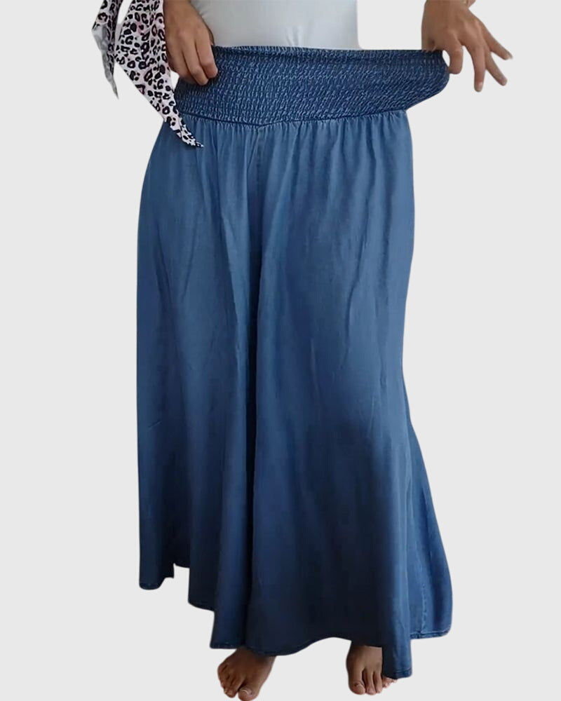 Side profile of a woman walking in the blue Seraphina maxi skirt, demonstrating the freedom of movement and elegant drape.